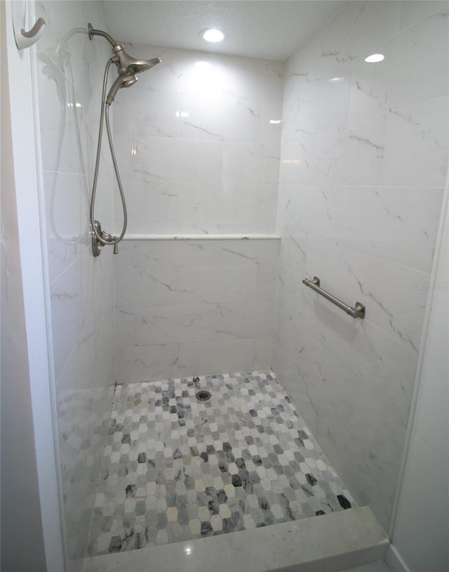 bathroom with tiled shower