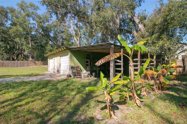 view of outdoor structure featuring a garage and a lawn