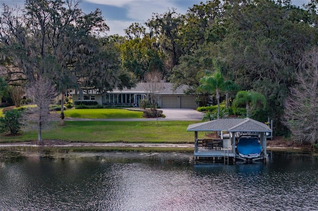 dock area with a lawn and a water view