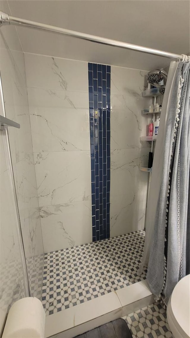 bathroom featuring toilet and walk in shower