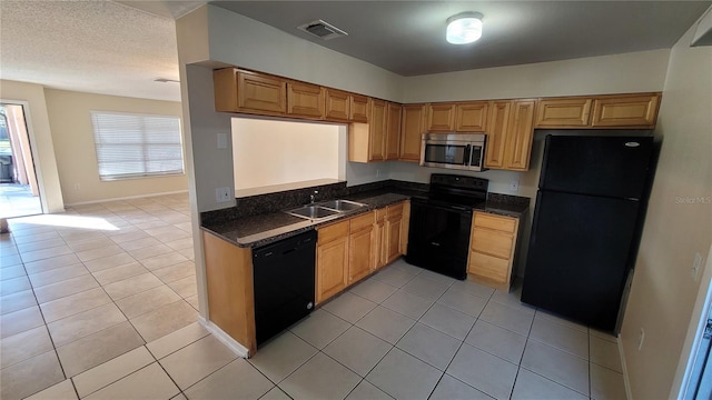 kitchen featuring light tile patterned floors, visible vents, a sink, a textured ceiling, and black appliances