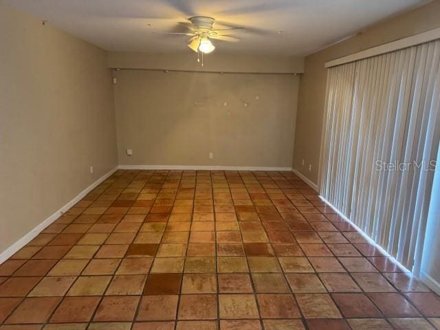 tiled empty room with ceiling fan