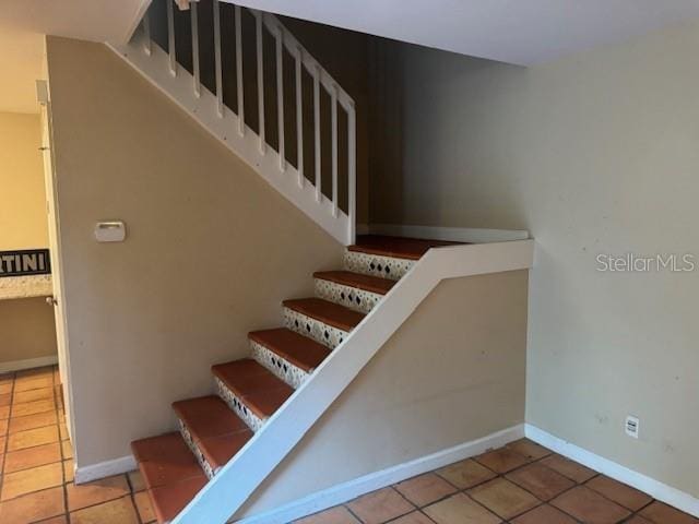 staircase featuring tile patterned floors