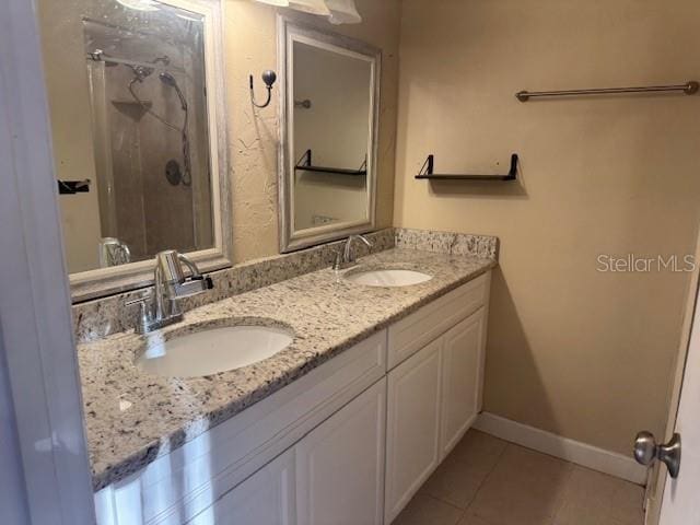 bathroom with vanity, tile patterned floors, and walk in shower