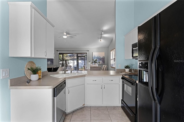 kitchen with white cabinetry, kitchen peninsula, light tile patterned floors, and black appliances