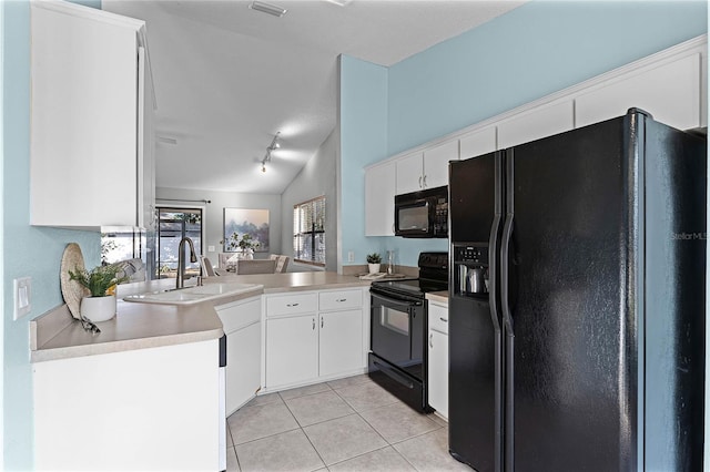 kitchen featuring sink, black appliances, light tile patterned floors, kitchen peninsula, and white cabinets