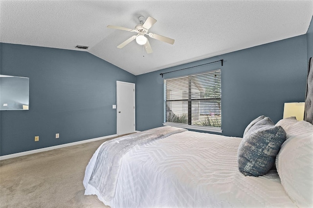 carpeted bedroom with lofted ceiling, ceiling fan, and a textured ceiling