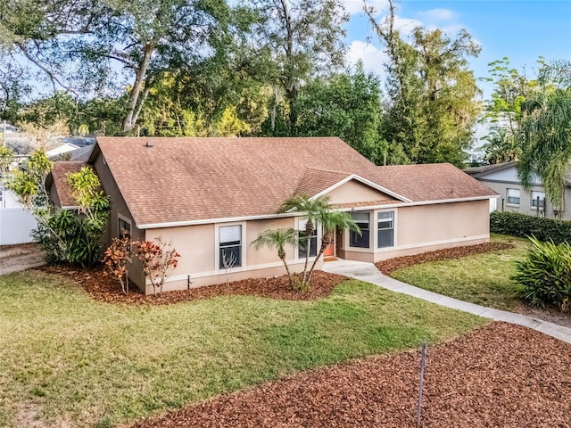 ranch-style home with a front lawn