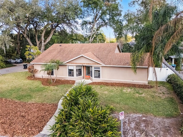 ranch-style home with a front yard