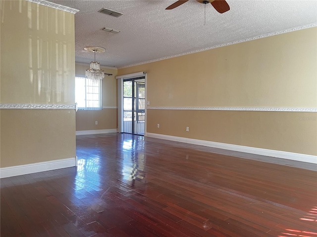 spare room featuring crown molding, ceiling fan with notable chandelier, a textured ceiling, and dark hardwood / wood-style flooring