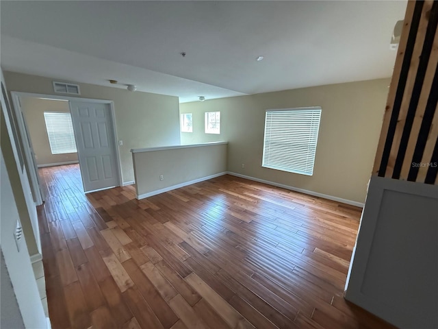 empty room featuring hardwood / wood-style flooring and a wealth of natural light