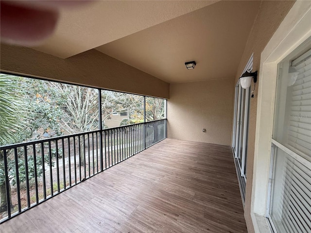 unfurnished sunroom with vaulted ceiling