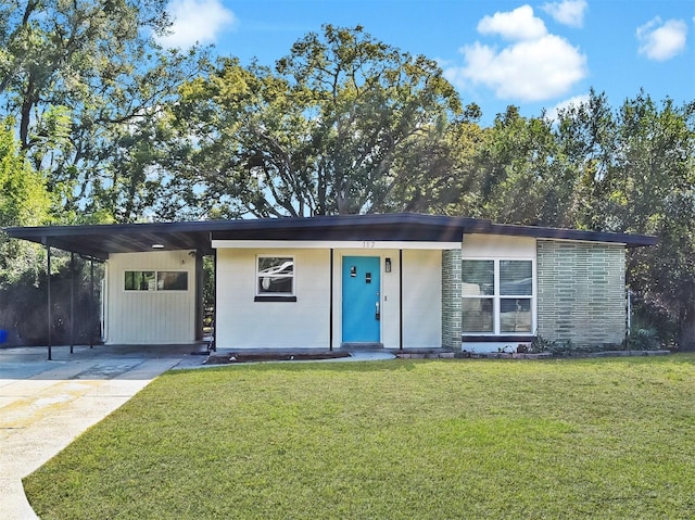 ranch-style house with a carport and a front yard