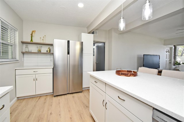 kitchen featuring white cabinetry, decorative light fixtures, light hardwood / wood-style flooring, dishwashing machine, and beam ceiling