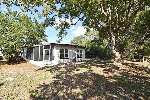 rear view of property with a sunroom