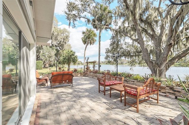 view of patio / terrace with an outdoor living space and a water view