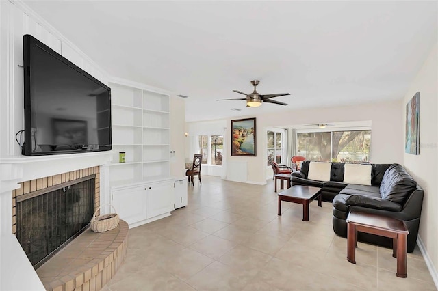 living room featuring light tile patterned floors, a fireplace, and ceiling fan