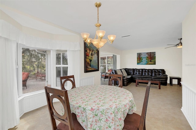 dining area featuring ceiling fan with notable chandelier and light tile patterned flooring