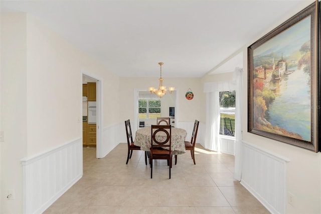 dining space featuring light tile patterned floors, a chandelier, and a healthy amount of sunlight