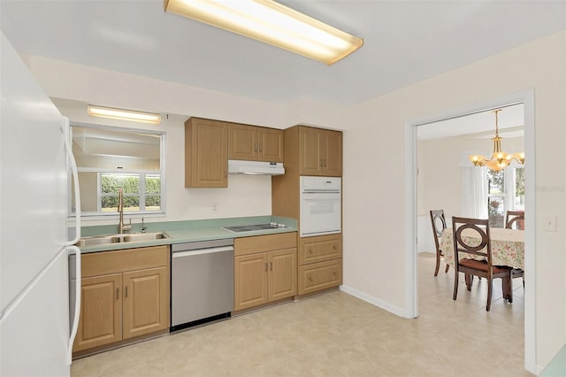 kitchen with sink, pendant lighting, a notable chandelier, and white appliances