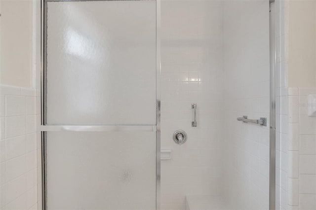 bathroom featuring tile walls and walk in shower