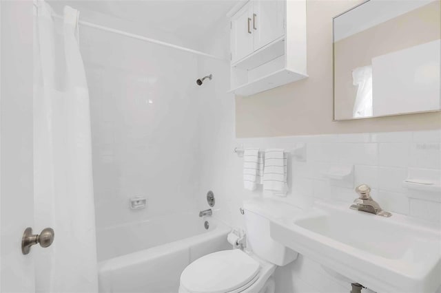 full bathroom with tile walls, sink, shower / bathtub combination, and toilet