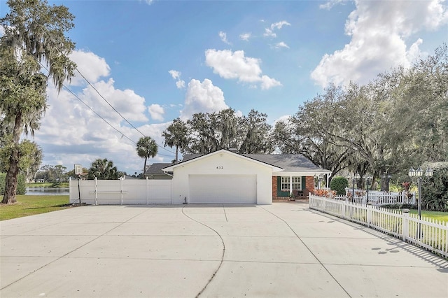 view of front of house featuring a garage and a water view