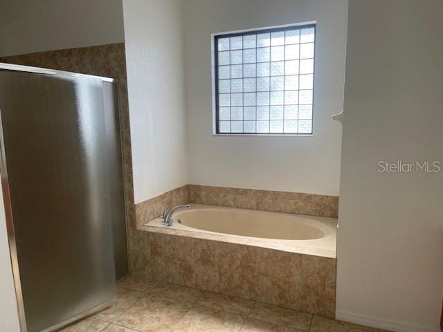 bathroom with tile patterned floors and plus walk in shower