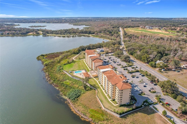 aerial view featuring a water view and a wooded view