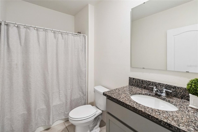 bathroom featuring tile patterned floors, vanity, and toilet