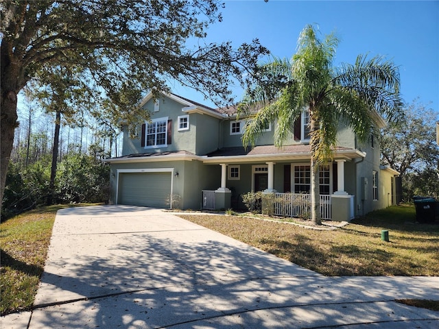 view of front of home with a garage, a front lawn, and a porch