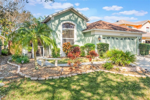 view of front of house featuring a garage and a front yard