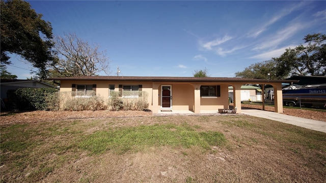 ranch-style house featuring a carport and a front yard