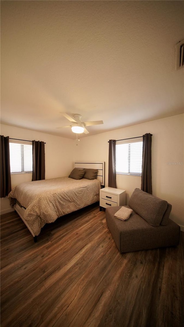 bedroom featuring dark wood-style flooring and ceiling fan