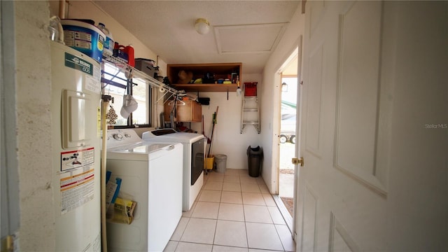 clothes washing area with laundry area, water heater, washing machine and clothes dryer, and light tile patterned floors