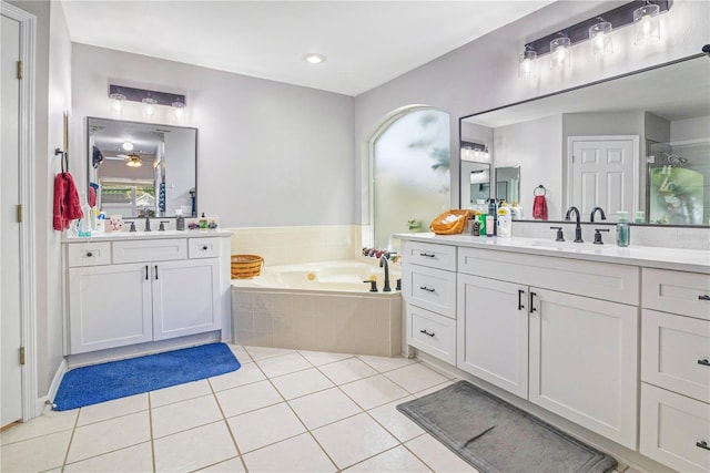 full bathroom featuring a bath, two vanities, a sink, and tile patterned floors