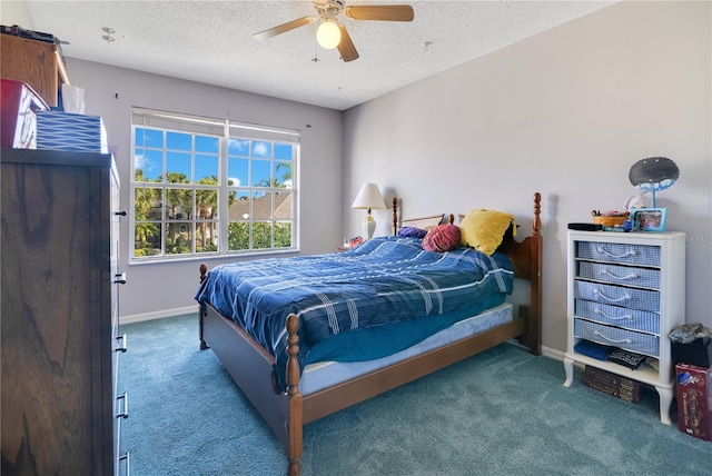 carpeted bedroom featuring a ceiling fan, a textured ceiling, and baseboards