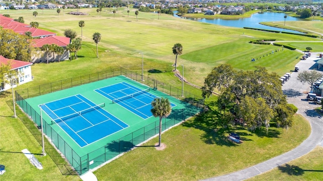 birds eye view of property with a water view and golf course view