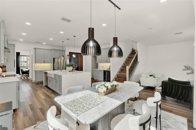 dining room with wine cooler and light hardwood / wood-style floors