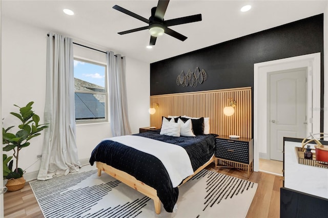 bedroom with light hardwood / wood-style floors and ceiling fan