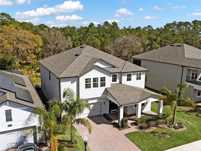 view of front facade featuring a garage and a front lawn