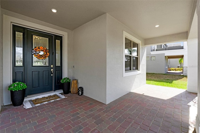 view of exterior entry featuring covered porch