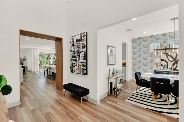 interior space with an inviting chandelier and light wood-type flooring