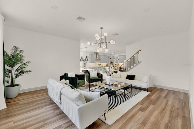 living room featuring light hardwood / wood-style flooring and a notable chandelier