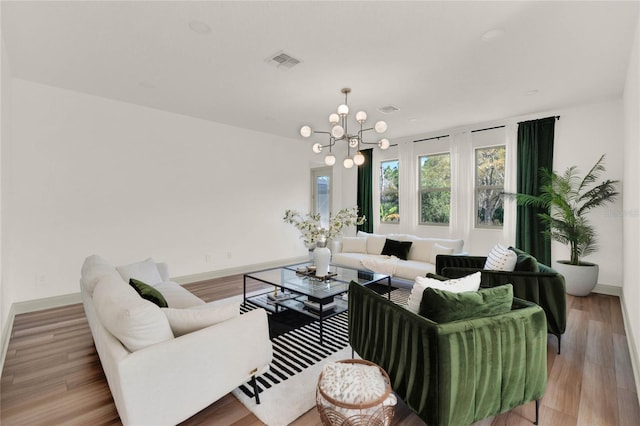 living room with a chandelier and light wood-type flooring