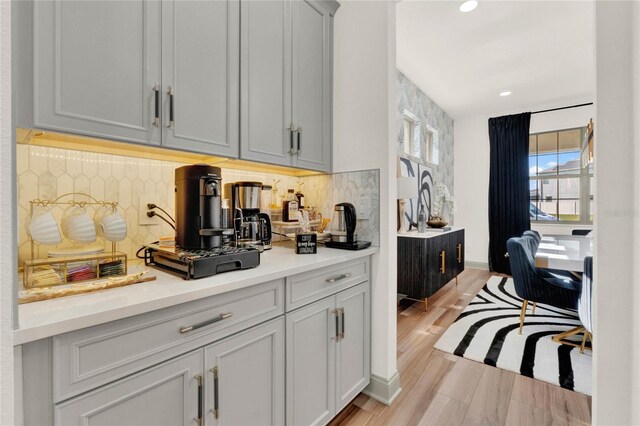 kitchen with backsplash and light hardwood / wood-style floors