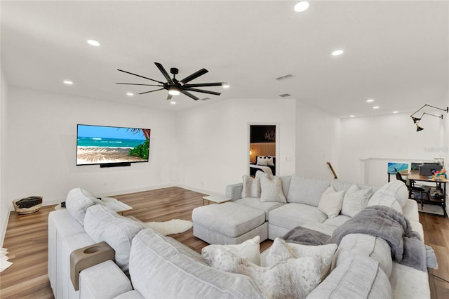 living room featuring ceiling fan and light hardwood / wood-style flooring