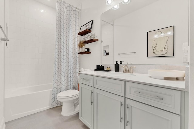 full bathroom featuring tile patterned floors, vanity, toilet, and shower / bath combo with shower curtain