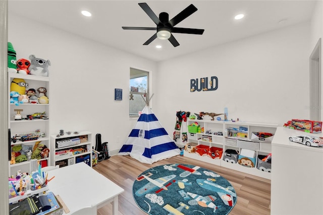 recreation room featuring ceiling fan and light hardwood / wood-style floors