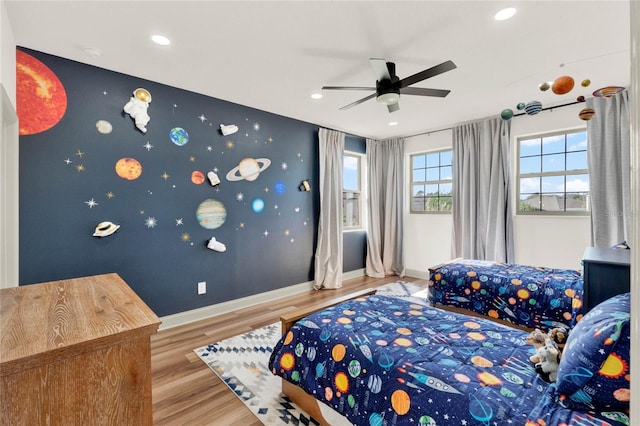 bedroom with ceiling fan and light wood-type flooring